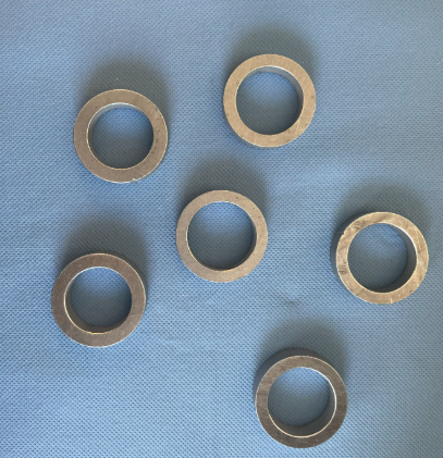 Six metal rings on a textured blue cloth