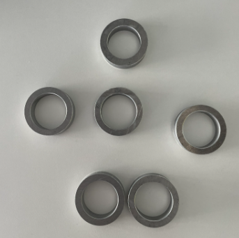 Six metal rings on a light grey background
